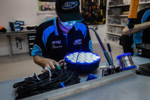 Ultra Vision factory worker assembling LED light